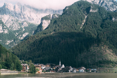 Scenic view of sea against mountains alleghe, italian dolomites