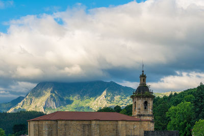 Low angle view of building against cloudy sky