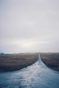 Empty road along landscape