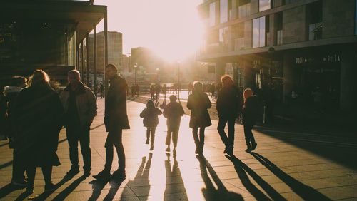 People walking on sidewalk in city