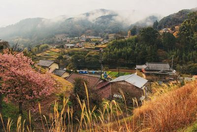 Panoramic view of houses and mountains against sky