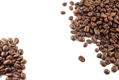 High angle view of coffee beans against white background