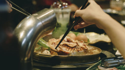 Close-up of hand holding ice cream in restaurant