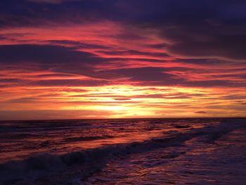 Scenic view of sea against romantic sky at sunset