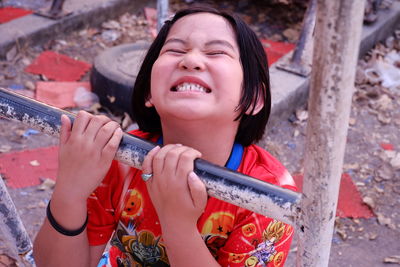 High angle view of smiling girl holding metal