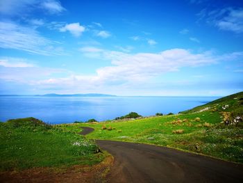 Road by sea against sky