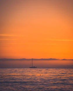 Scenic view of sea against orange sky