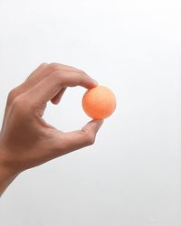 Person holding apple against white background