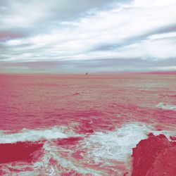 Scenic view of sea against cloudy sky