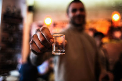 Man showing shot glass