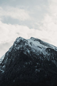 Low angle view of snowcapped mountains against sky