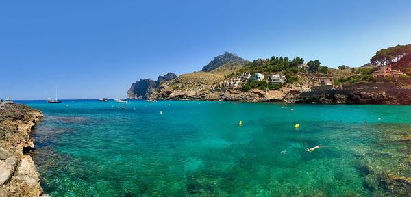 Scenic view of sea against clear blue sky