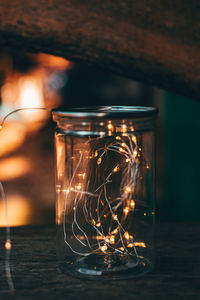 Close-up of illuminated candles on table