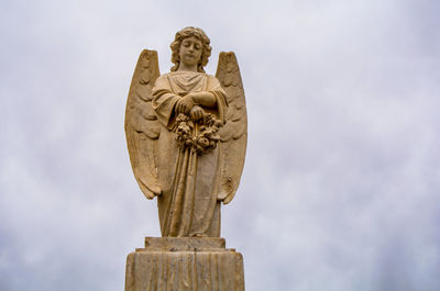 Low angle view of statue against sky