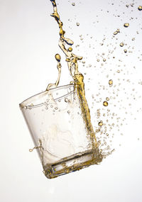 Close-up of ice pouring over white background