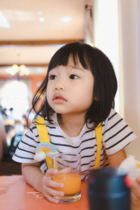 Portrait of cute girl drinking glass