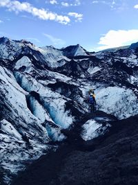 Man on snowcapped mountain against sky