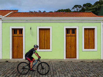 Full length of man riding bicycle