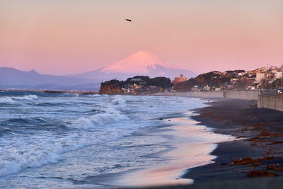 Scenic view of beach against sky during sunrise