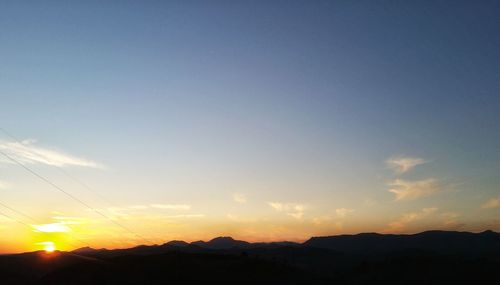 Scenic view of silhouette mountains against sky during sunset