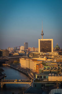 Mid distance view of fernsehturm against clear sky in city