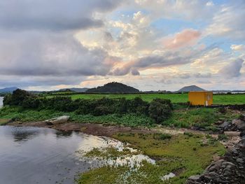 Scenic view of lake by buildings against sky