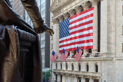 Low angle view of flag against buildings in city