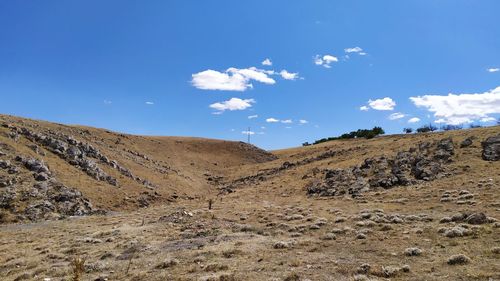 Scenic view of arid landscape against sky