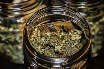 High angle view of cigarette in glass jar on table