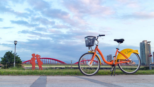 Bicycle on road against sky