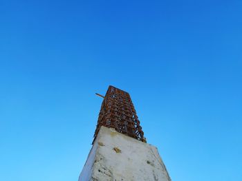 Low angle view of old building against blue sky