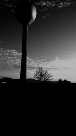 Silhouette trees against sky at sunset