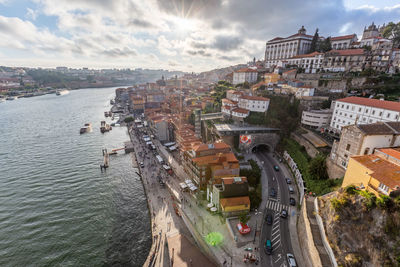 High angle view of townscape by sea against sky