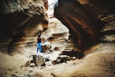 Rear view of man standing on rock