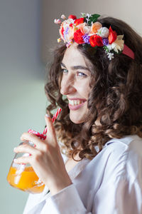 Close-up of smiling woman holding drink