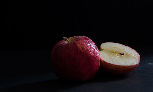 Close-up of apples on table against black background