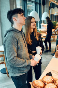 Friends doing shopping in a coffee shop. young man and woman having picking out the food