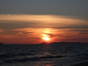 Scenic view of sea against romantic sky at sunset