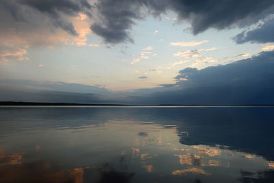 Reflection of the sky in the lake water in the calmness at sunset