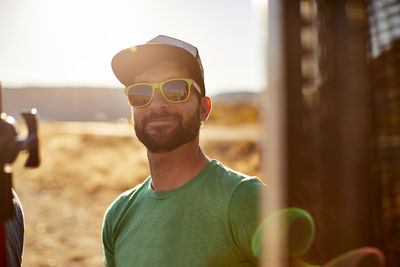 An outdoor portrait of a man in sunglasses.