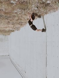 Woman jumping on wall