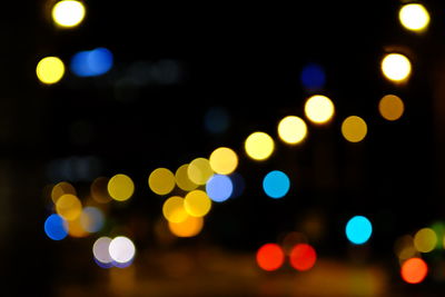 Defocused image of illuminated street lights at night