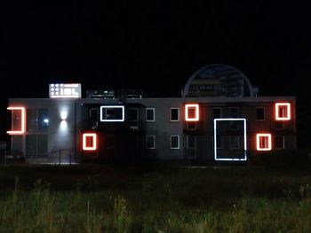 Train on field against sky at night