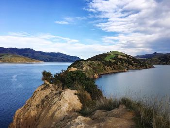 Scenic view of sea and mountains against sky