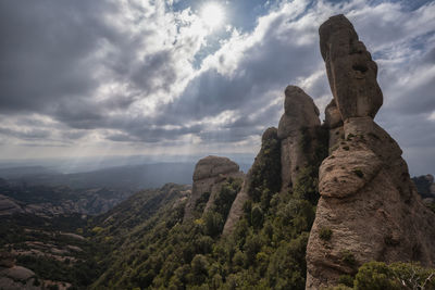 Low angle view of rock formation against sky