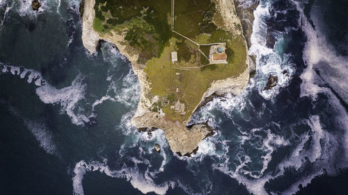 High angle view of rock formation by sea