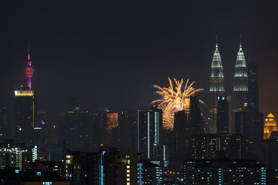 Low angle view of skyscrapers lit up at night
