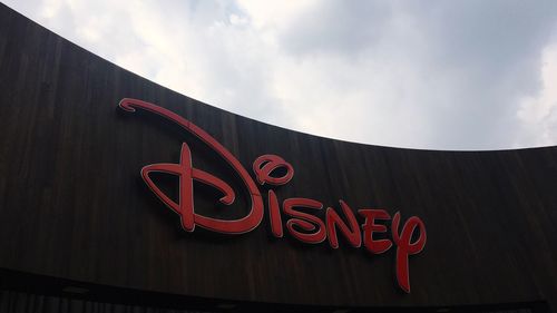 Low angle view of illuminated sign against sky