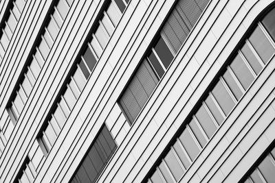 Low angle view of modern glass building in city