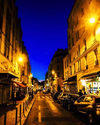 Illuminated city street at night